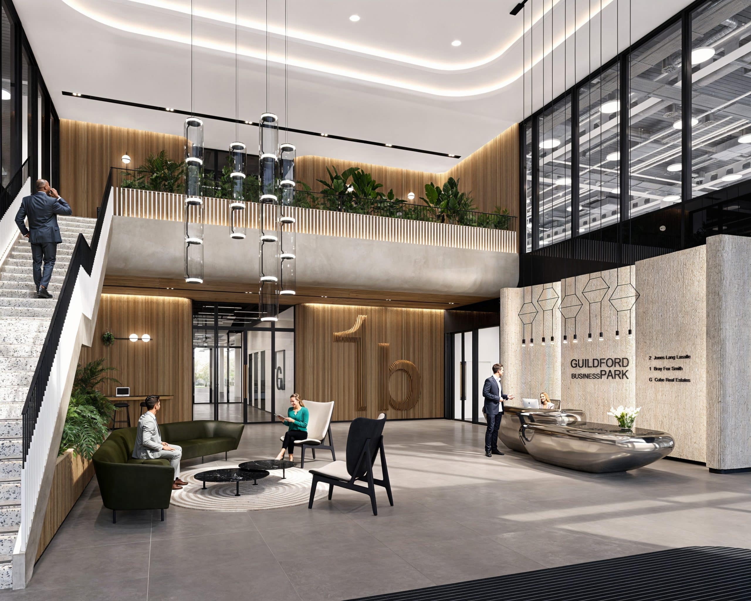Modern lobby with seating, stairs, and reception desk. People are present in the stylish, open space.