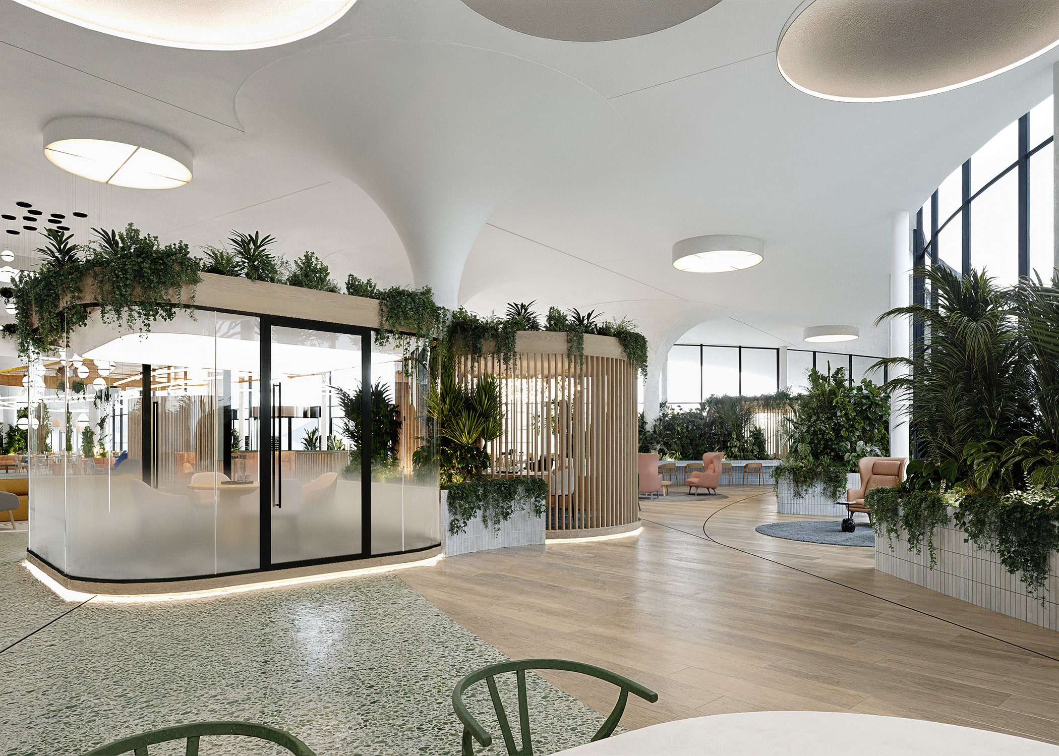 Modern office space with plants, large windows, and seating areas.