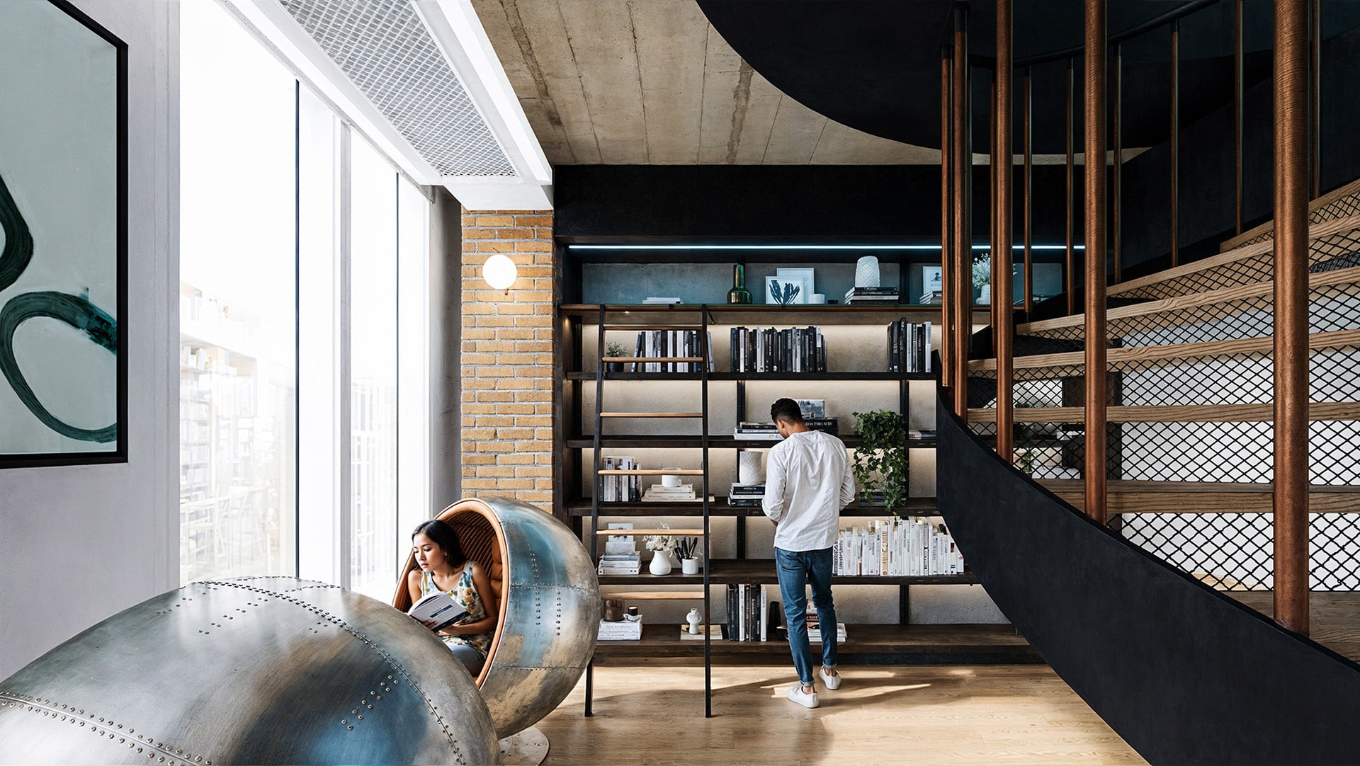 Modern loft with a person reading in a pod chair and another browsing a bookshelf.