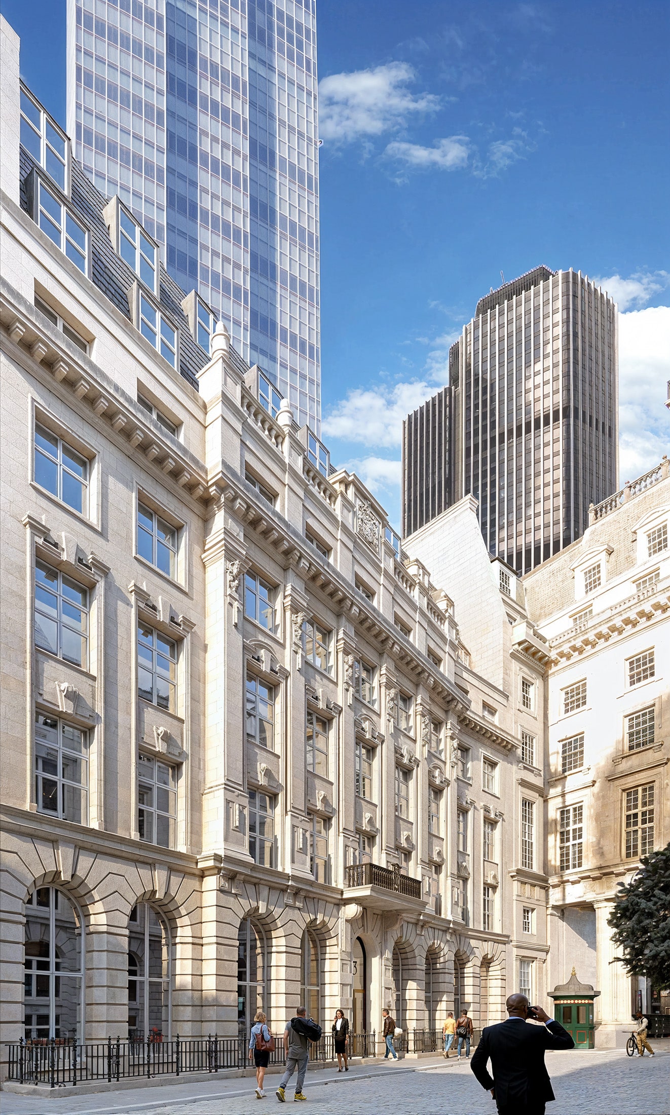 Street with historic and modern buildings under a clear blue sky.
